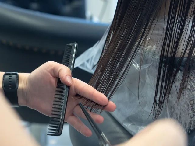 Close-up of a professional haircut in progress at a salon, highlighting comb and scissors. London vs Manchester vs Glasgow, how wolf cut demand and pricing differ